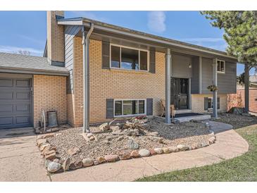 Charming two-story home features a well-maintained lawn and traditional brick facade at 13086 E Alaska Ave, Aurora, CO 80012