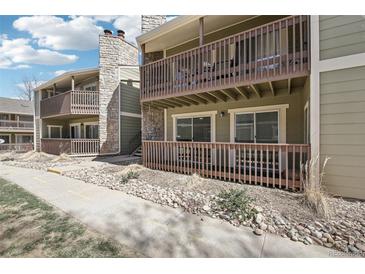 The exterior shows a multi-story condominium building with balconies and stone accents at 3450 S Eagle St # 101, Aurora, CO 80014