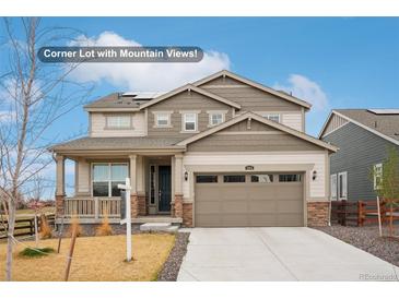 Charming two-story home with a two-car garage, inviting porch, and complementary neutral color palette at 1884 Myron Ct, Erie, CO 80516