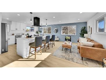 Open-concept living room featuring a modern kitchen island and a comfortable seating area with stylish decor at 1173 Xenon St, Golden, CO 80401