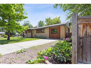 Charming home exterior with well-maintained lawn, landscaping, and a driveway at 2901 Lorraine Ct, Boulder, CO 80304