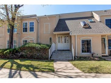 Charming townhome featuring a well-maintained lawn, inviting entryway, and classic architectural details at 2870 S Ursula St, Aurora, CO 80014