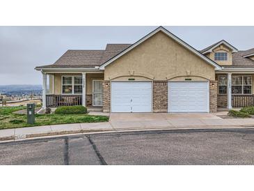 Charming townhome featuring a two-car garage and inviting front porch with views at 1335 Villa Grv # 30, Monument, CO 80132