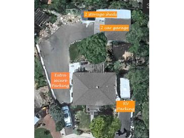 Aerial view of property showing extra secure parking, 2 car garage, RV parking and two storage sheds at 6361 S Spotswood Cir, Littleton, CO 80120