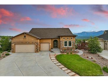 Charming single-Gathering home featuring a well-manicured lawn, three-car garage, and stunning mountain views at 15506 Short Line Ct, Monument, CO 80132