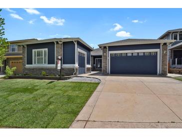Charming home featuring a two-car garage and a well-maintained lawn with stunning curb appeal at 2485 Vale Way, Erie, CO 80516