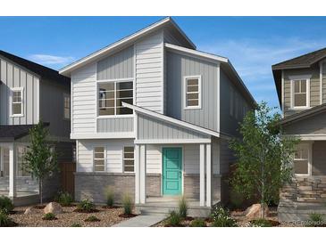 Charming two-story home with modern design, light gray siding, and a welcoming teal-colored front door at 5240 Denali Blvd, Aurora, CO 80019