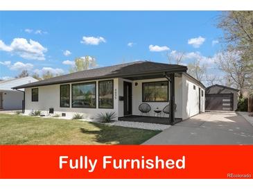 Charming home featuring a well-maintained lawn and inviting front porch seating area at 4895 E Arizona Ave, Denver, CO 80246