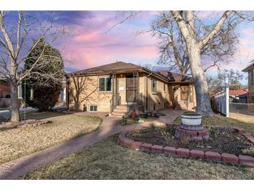 Charming brick home featuring a well-manicured front yard and inviting entrance at 2434 S Ogden St # 2434-2436, Denver, CO 80210