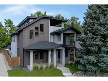 Modern two-story home boasts mixed material facade, covered entry, and manicured landscaping at 2540 Xavier St, Denver, CO 80212