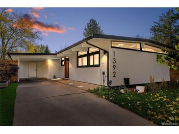 Striking modern home featuring a unique roofline, white siding, and well-manicured landscaping at 1392 S Edison Way, Denver, CO 80222