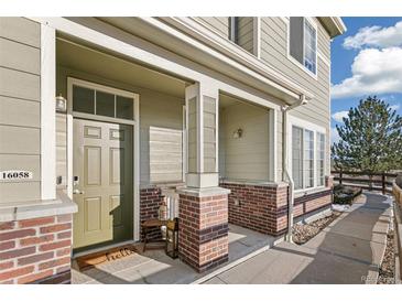 Inviting front porch and walkway leading to the entrance of this charming townhome at 16058 E Geddes Ln # 26, Aurora, CO 80016