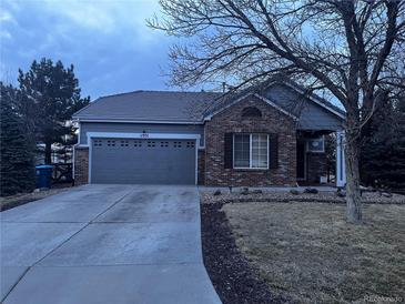 Brick ranch home with attached garage and landscaping at 11931 Fairplay St, Commerce City, CO 80603