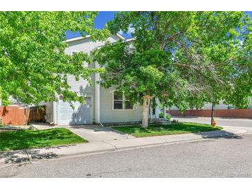 Charming two-story home with attached garage, mature trees, and a well-maintained front yard at 11803 W Tufts Pl, Morrison, CO 80465