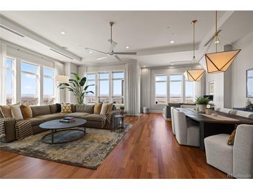 Bright open living space with hardwood floors and expansive windows showcasing city views at 5455 Landmark Pl # 1106, Greenwood Village, CO 80111