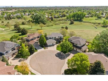Stunning aerial view of homes on a cul-de-sac with golf course and lush green landscape at 8806 Tuscany Ln, Highlands Ranch, CO 80130
