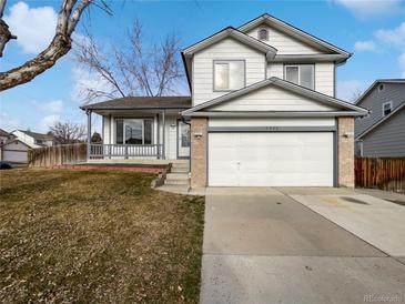 Two-story house with attached garage and manicured lawn at 5599 W 115Th Ave, Westminster, CO 80020