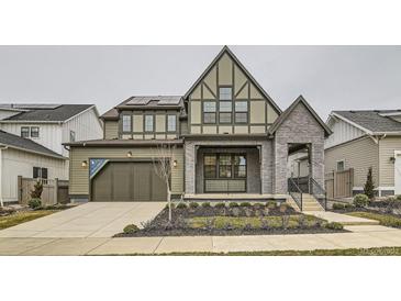 Two-story craftsman style home with gray brick and green siding at 1853 Hickory Ave, Erie, CO 80516