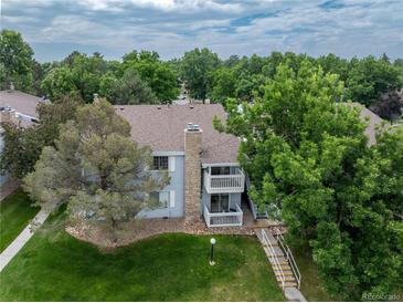 Inviting two-story condo with dual balconies, stone chimney and lush green landscape at 13404 E Jewell Ave # 101, Aurora, CO 80012