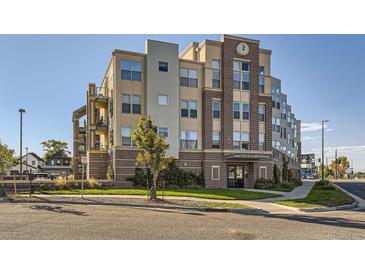 Inviting multi-story condo building with brick facade and manicured landscaping at 1313 S Clarkson St # 205, Denver, CO 80210