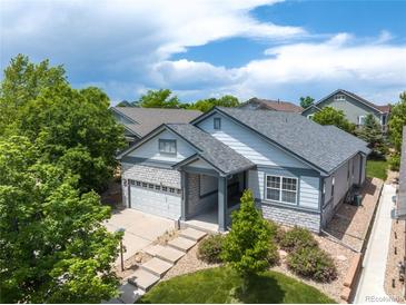 Beautiful aerial view of a single Gathering home with a well-manicured front yard, landscaping, and a two-car garage at 23421 E Long Pl, Aurora, CO 80016