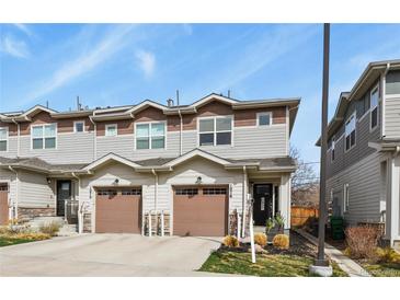 Townhome with a attached garage and neutral siding at 1078 Oak Cir, Denver, CO 80215