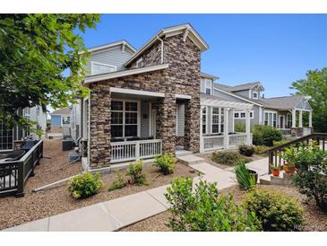 Charming two-story home with stone accents and a landscaped front yard at 5723 S Union Ct, Littleton, CO 80127