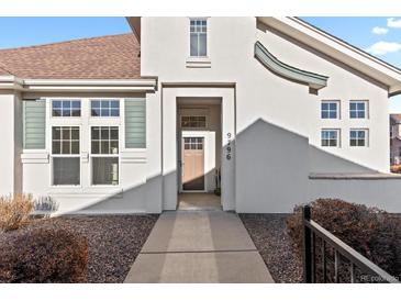 Inviting front entrance with a contemporary design and meticulously maintained landscaping at 9796 W Hinsdale Pl # 4, Littleton, CO 80128