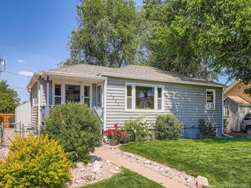 Charming single-story home with well-maintained lawn, lush landscaping, and a welcoming walkway at 3645 S Fox St, Englewood, CO 80110