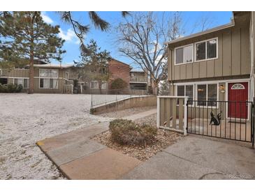 Condo complex exterior with mature trees, snow-dusted lawn, and well-maintained landscaping provides a welcoming atmosphere at 857 S Van Gordon Ct # H101, Lakewood, CO 80228