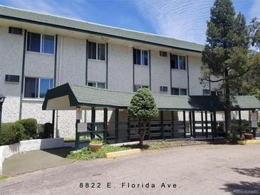 Apartment building exterior with covered entry, and manicured landscaping at 8826 E Florida Ave # 204, Denver, CO 80247