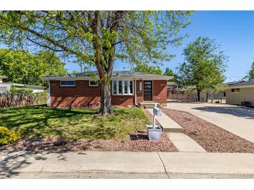Charming red brick home with a well-maintained front yard and a mature shade tree at 4953 W 61St Ave, Arvada, CO 80003