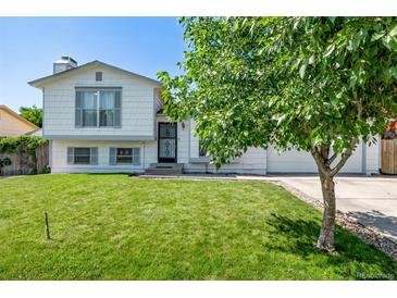 Charming two-story home with a lush green lawn and a well-maintained exterior at 4416 E 93Rd Pl, Thornton, CO 80229