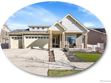 Charming home featuring a three car garage, stone accents, and a well maintained lawn at 5474 Espana St, Denver, CO 80249