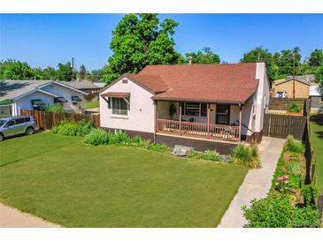 Charming brick home featuring a well-manicured lawn and a cozy, covered front porch at 4268 S Delaware St, Englewood, CO 80110