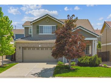 Charming two-story home features a two-car garage, brick accents, and well-maintained landscaping at 7342 S Mobile St, Aurora, CO 80016