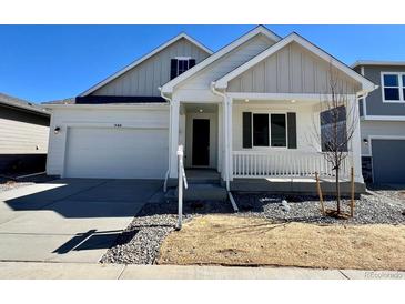 Charming single Gathering home featuring a two-car garage, covered porch, and professionally landscaped front yard at 240 Lark Sparrow Way, Bennett, CO 80102