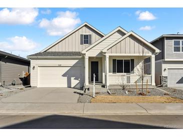 Charming single-Gathering home boasts a two-car garage and covered front porch, perfect for enjoying the outdoors at 240 Lark Sparrow Way, Bennett, CO 80102