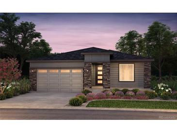 Charming single-story home boasts stone accents and a two-car garage with beautiful landscaping at 39210 Anthony St, Elizabeth, CO 80107