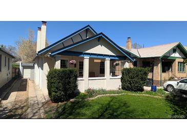 Charming bungalow with a well-maintained front yard and covered porch at 2377 Cherry St, Denver, CO 80207