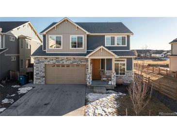 Two-story house with stone accents and a two-car garage at 16508 E 111Th Pl, Commerce City, CO 80022