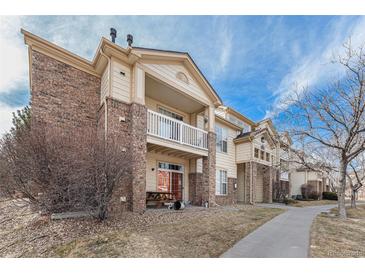 Charming condo building with private balcony and brick and siding exterior at 5694 N Gibralter Way # 203, Aurora, CO 80019