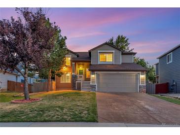 Charming two-story home featuring a well-manicured lawn and an attached two-car garage at 17166 Yellow Rose Way, Parker, CO 80134