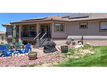 Inviting backyard featuring a patio area with outdoor furniture and a grill, perfect for entertaining at 10950 Elk Horn Run, Littleton, CO 80125