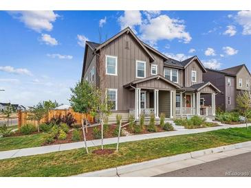 Beautiful two-story home featuring a covered porch and nicely landscaped front yard at 6105 N Hanover St, Denver, CO 80238