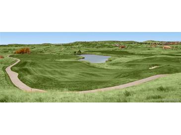 Beautiful golf course view with lush green fairways and a scenic pond at 5603 Twilight Way, Parker, CO 80134