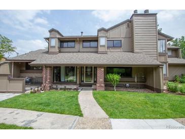 Charming multi-story home with well-maintained lawn, brick accents, and inviting entryway at 10652 W Florida Ave # D, Lakewood, CO 80232