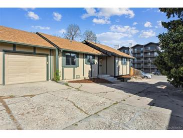 Charming single-story home with a tan exterior, brown roof, attached garage, and concrete driveway at 4710 E Louisiana Ave, Denver, CO 80246