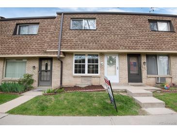 Charming townhouse exterior featuring brick facade and well-maintained landscaping at 13043 W 20Th Ave, Golden, CO 80401