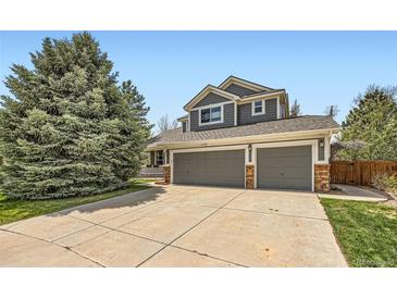 Charming two-story home featuring a three car garage and beautiful mature trees at 11321 Mesa Verde Pl, Parker, CO 80138